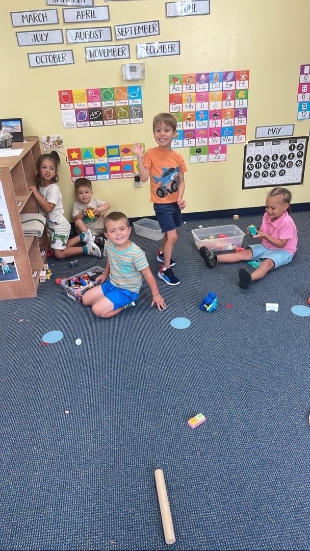 Teacher reading to toddlers at Sunshine Prep Academy